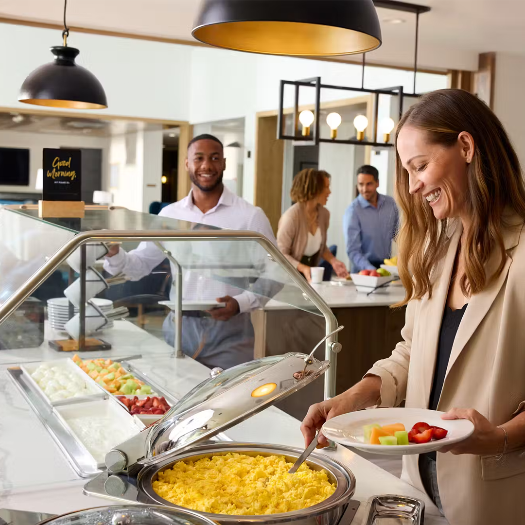 Colleagues enjoying a breakfast buffet at a hotel.